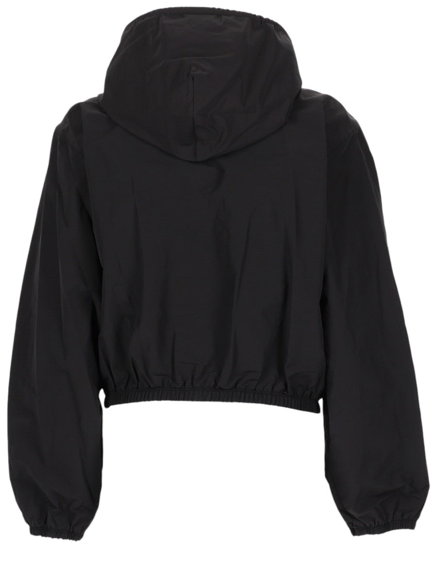 Alexander Wang black cropped hooded jacket for women featuring a front zip closure, drawstring hood, logo detail, and elastic hem.
