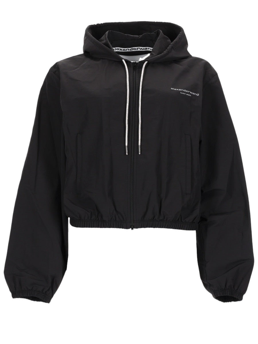Alexander Wang black cropped hooded jacket for women featuring a front zip closure, drawstring hood, logo detail, and elastic hem.