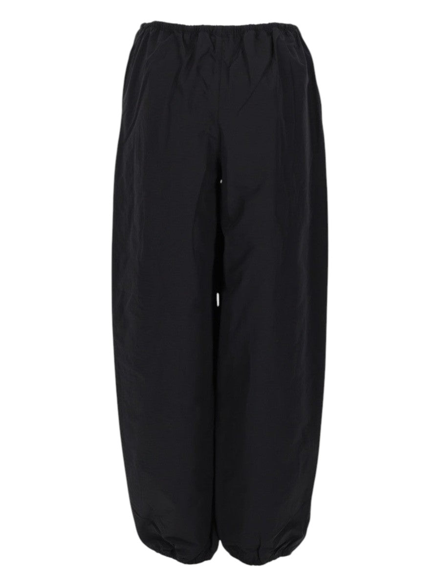 Alexander Wang black technical track pants for women featuring an elastic drawstring waistband, , and relaxed wide-leg silhouette.