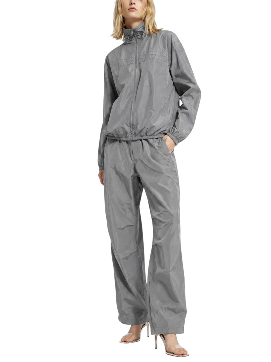 Model wearing an Alexander Wang gray technical jacket with matching gray pants, creating a modern sporty-chic look.