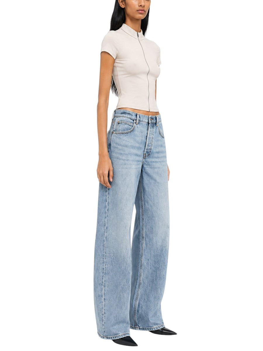 Model wearing Alexander Wang light blue wide-leg jeans with a fitted short-sleeve top and pointed-toe shoes.