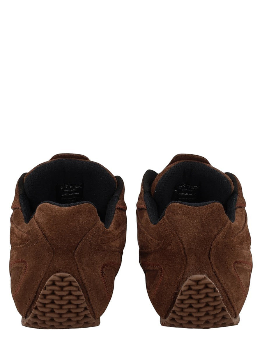 Rear view of the AXEL ARIGATO Slow Runner sneaker in brown suede with black collar lining and textured heel sole.