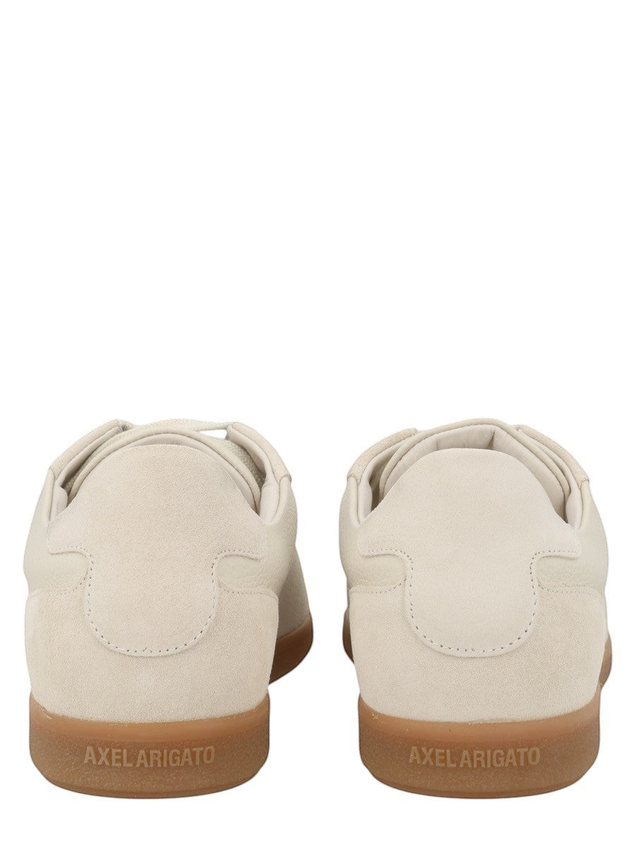 Rear view of the AXEL ARIGATO Zane sneaker in off white leather with suede heel panel and translucent gum rubber sole.