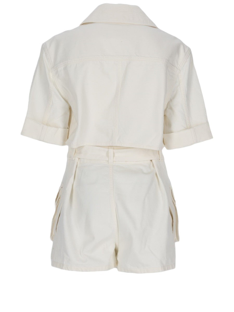 Back view of the Balmain Denim Belted Jumpsuit in ivory, showing the cropped shirt-style upper panel, short sleeves and tailored shorts.