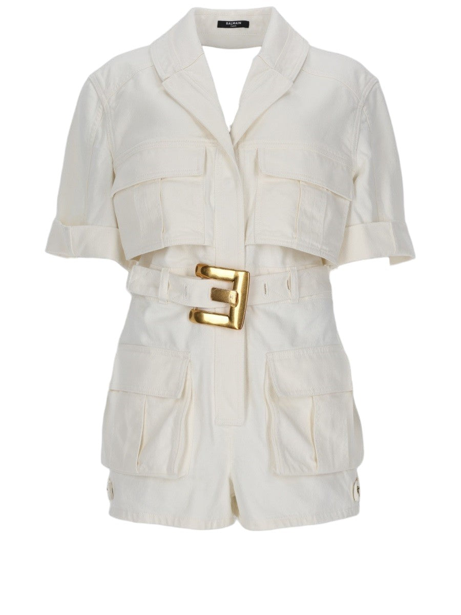 Front view of the Balmain Denim Belted Jumpsuit in ivory, featuring utility pockets, rolled short sleeves and a statement gold-tone belt buckle.