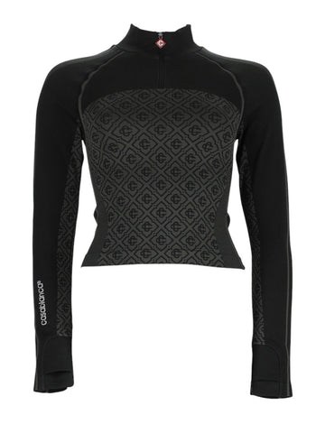 Front view of CASABLANCA black fitted top with zip collar, long sleeves and monogram jacquard panel