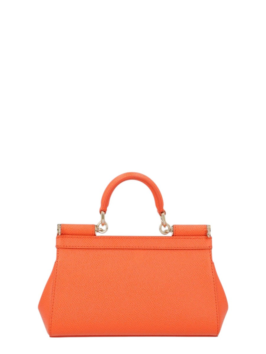Mini Sicily bag by Dolce & Gabbana in orange textured leather, shown from the back with structured top handle and gold-tone hardware.
