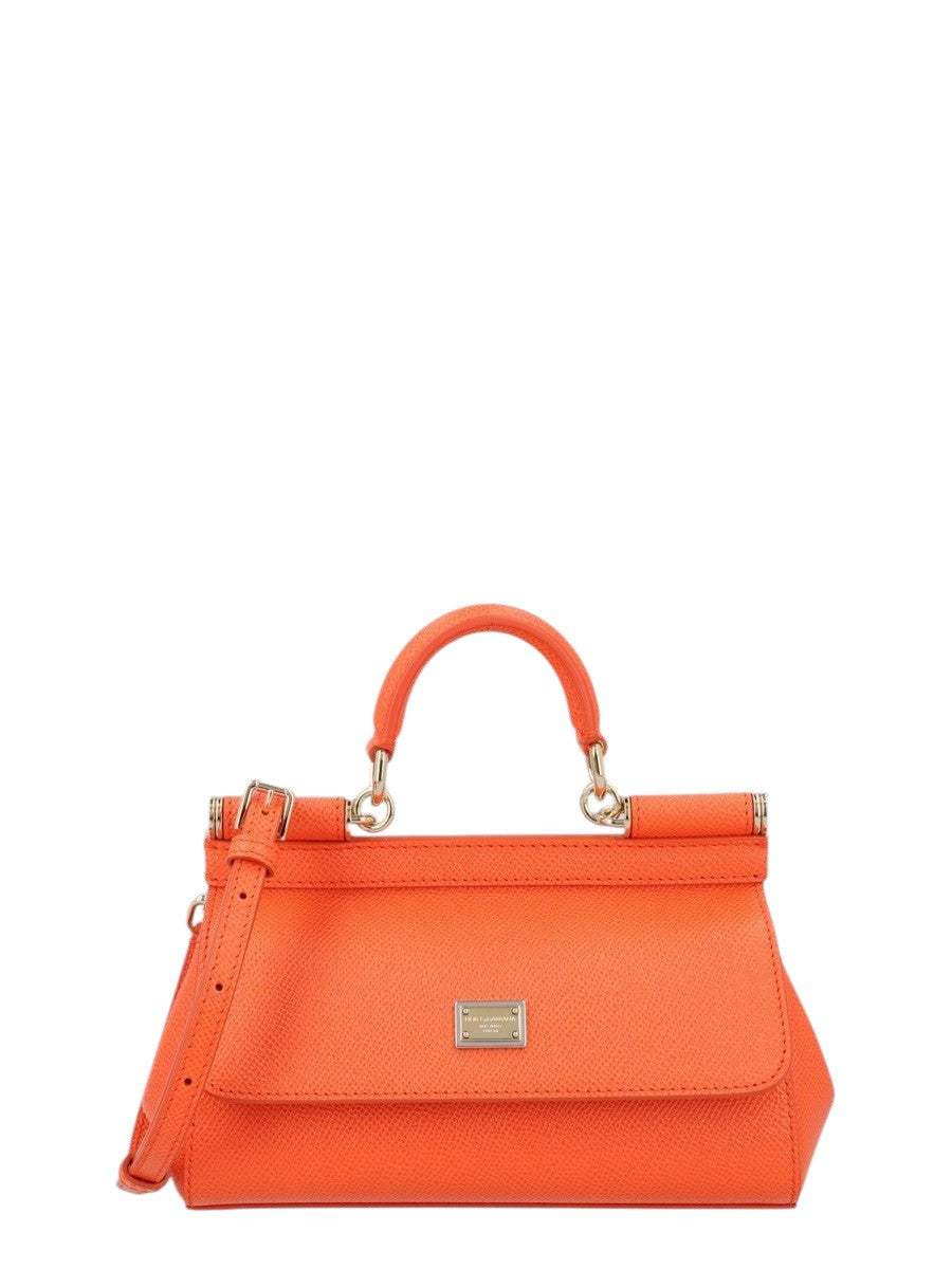 Dolce & Gabbana Mini Sicily bag in bright orange textured leather with top handle, detachable shoulder strap, front flap and logo plaque.