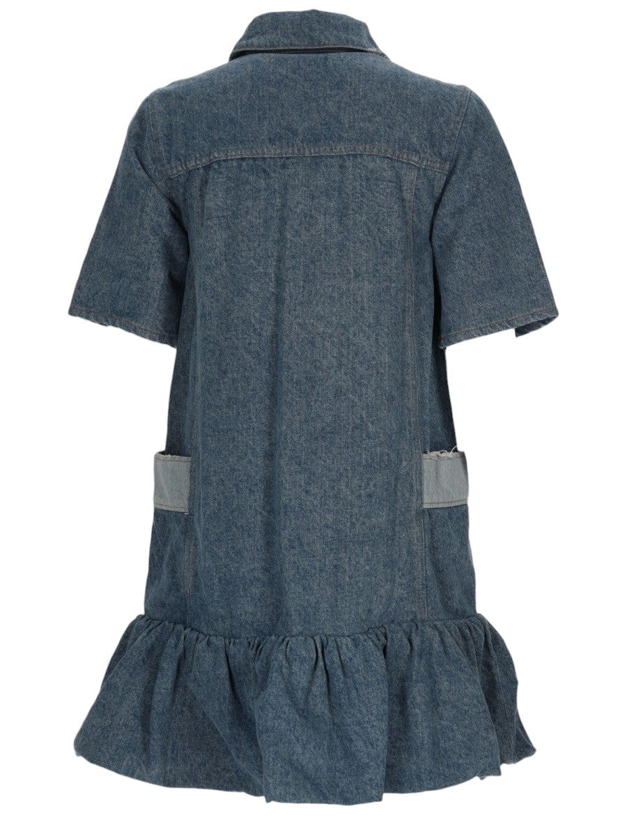 GANNI Patchwork Denim Mini Dress in blue, front view with short sleeves, buttoned polo collar, side patch pockets and gathered ruffle hem.