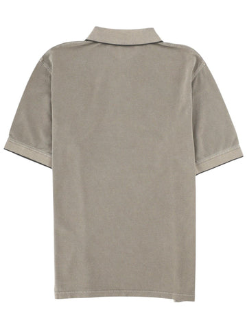 Back view of the Herno polo shirt in sage green cotton piqué, featuring a clean silhouette with contrast trim on the collar.