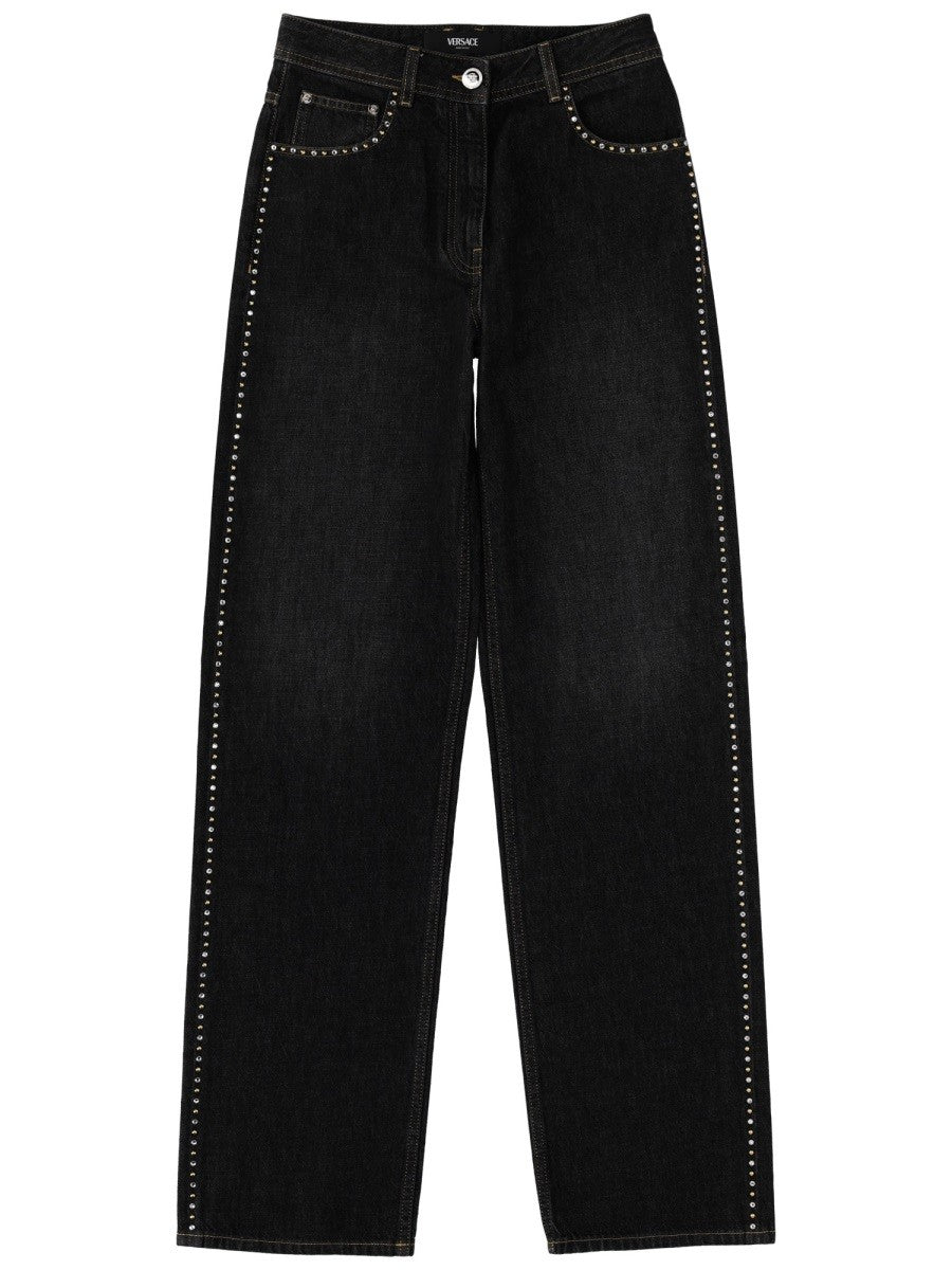 Versace - JEANS WITH STUDS AND CRYSTALS DECORATION jeans-with-studs-and-crystals-decoration_e61456bb-127c-4a99-96d9-0c39dda3bfa2