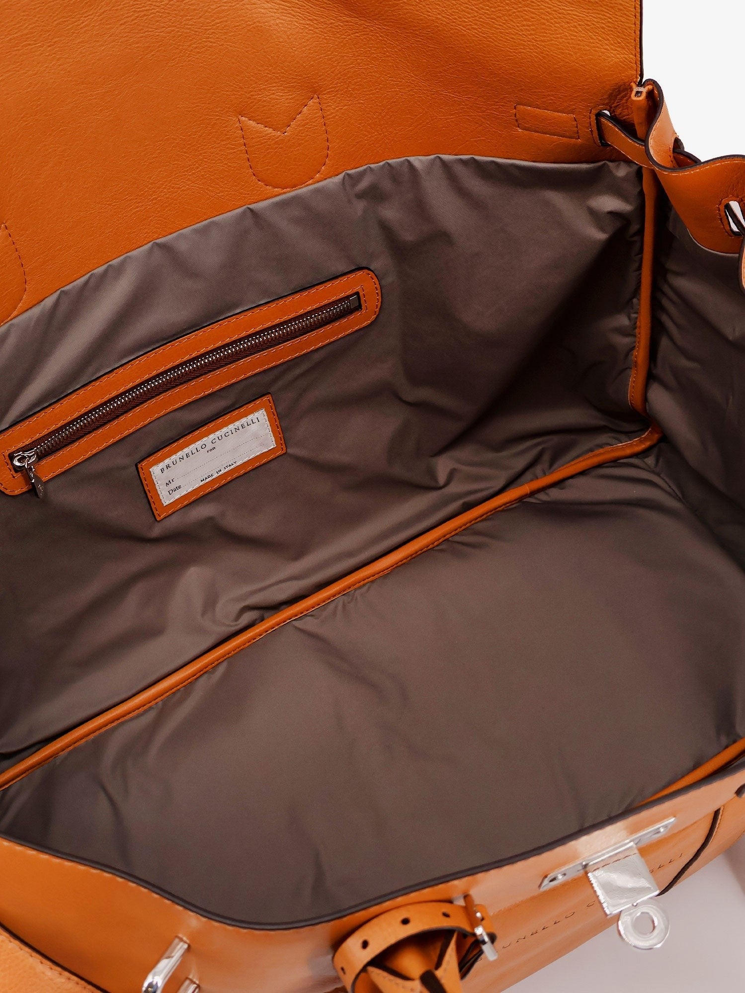 Leather travel bag with engraved logo on the front