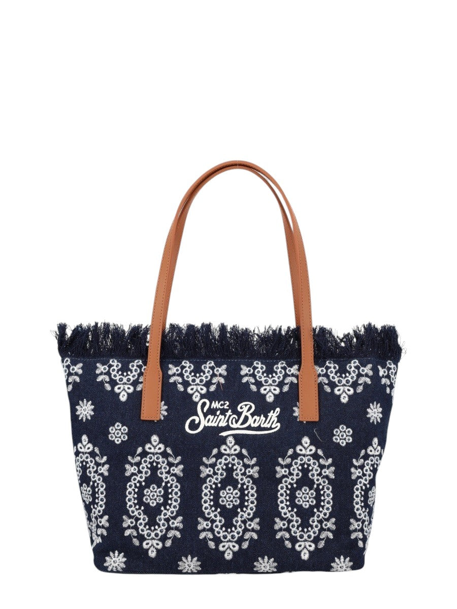 MC2 Saint Barth City Medium navy blue canvas tote bag featuring white embroidered ornamental motifs, frayed top edge and tan leather shoulder handles.