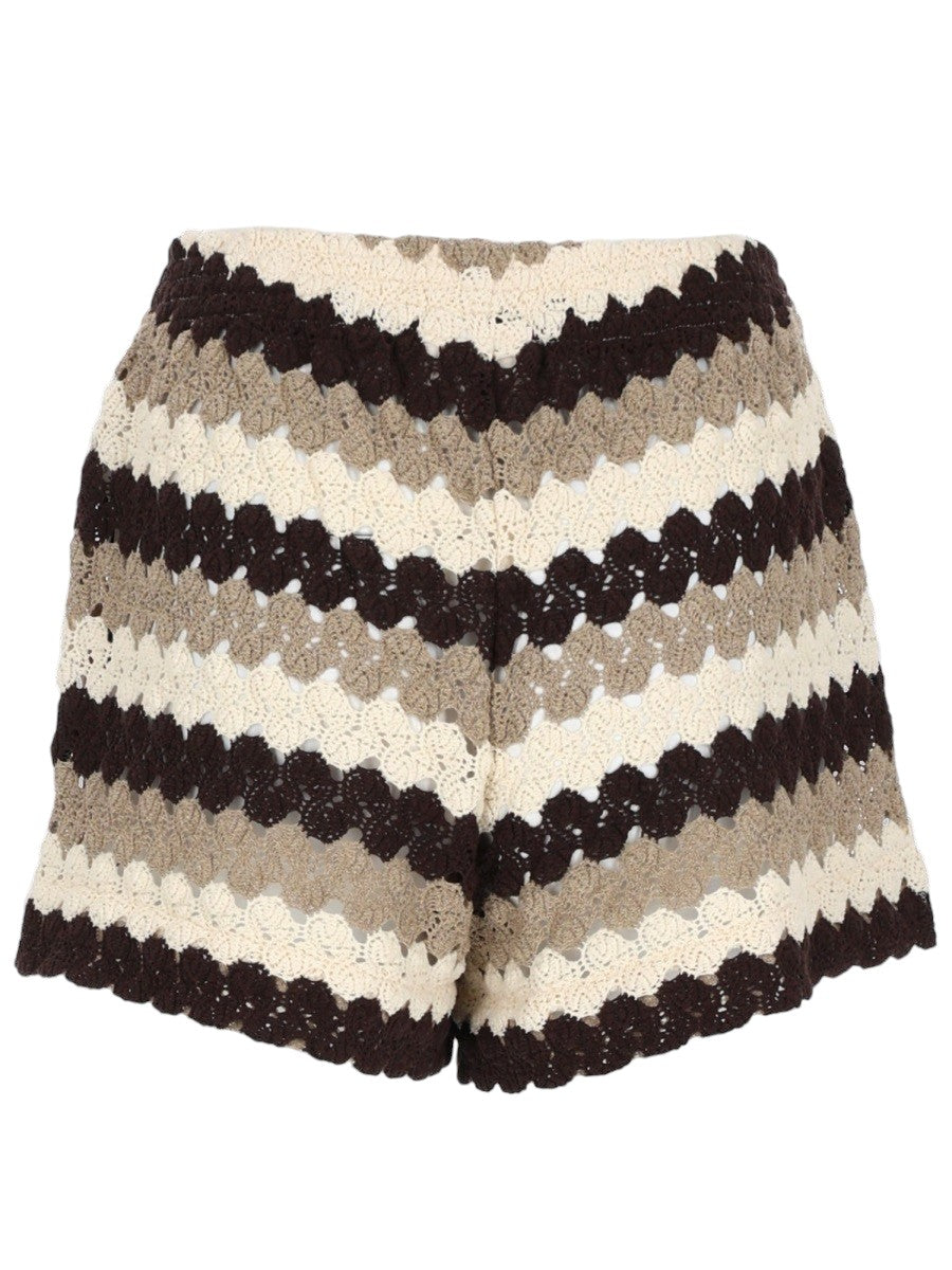 Back view of MC2 Saint Barth crochet stripe knit shorts in brown, beige and white with an openwork crochet pattern and elasticated waistband.