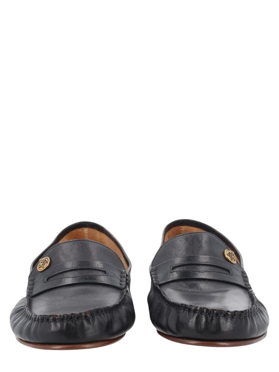 Versace black leather loafers with gold Medusa head detail. Made in Italy.