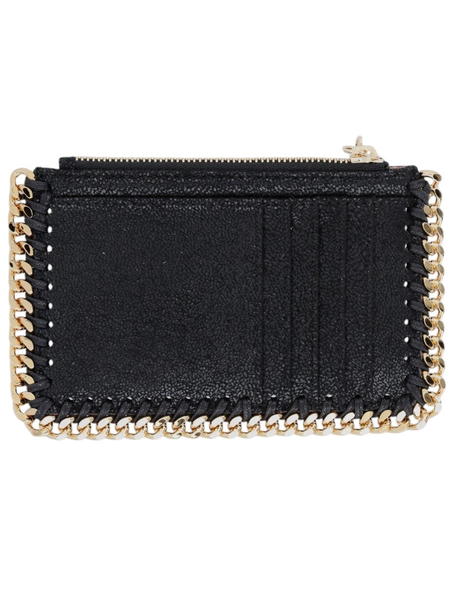 Stella McCartney Falabella zip card holder in black shaggy deer fabric featuring signature gold-tone chain trim and compact silhouette.