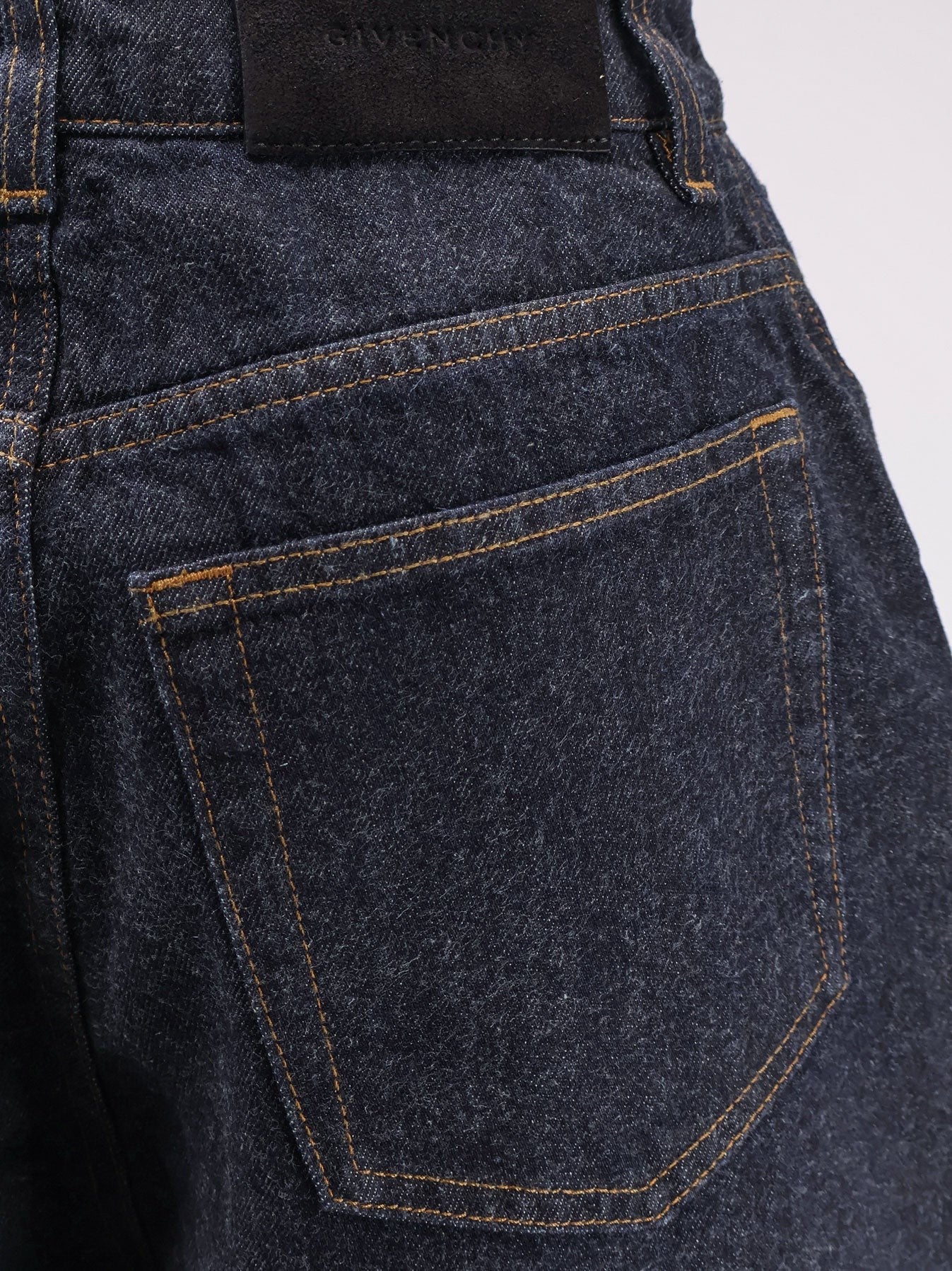 Twisted dark blue denim jeans